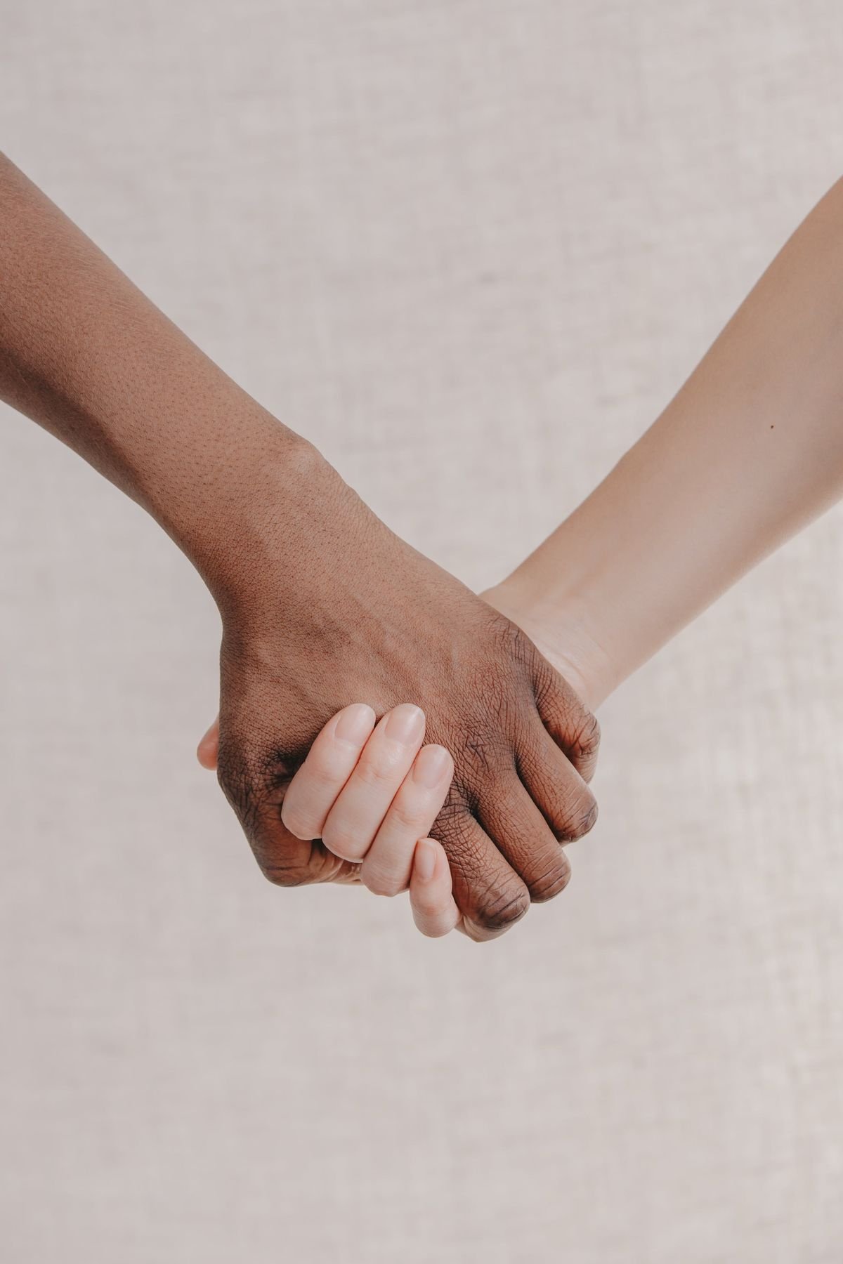 Two soft bands of light crossing on a pale pink wall